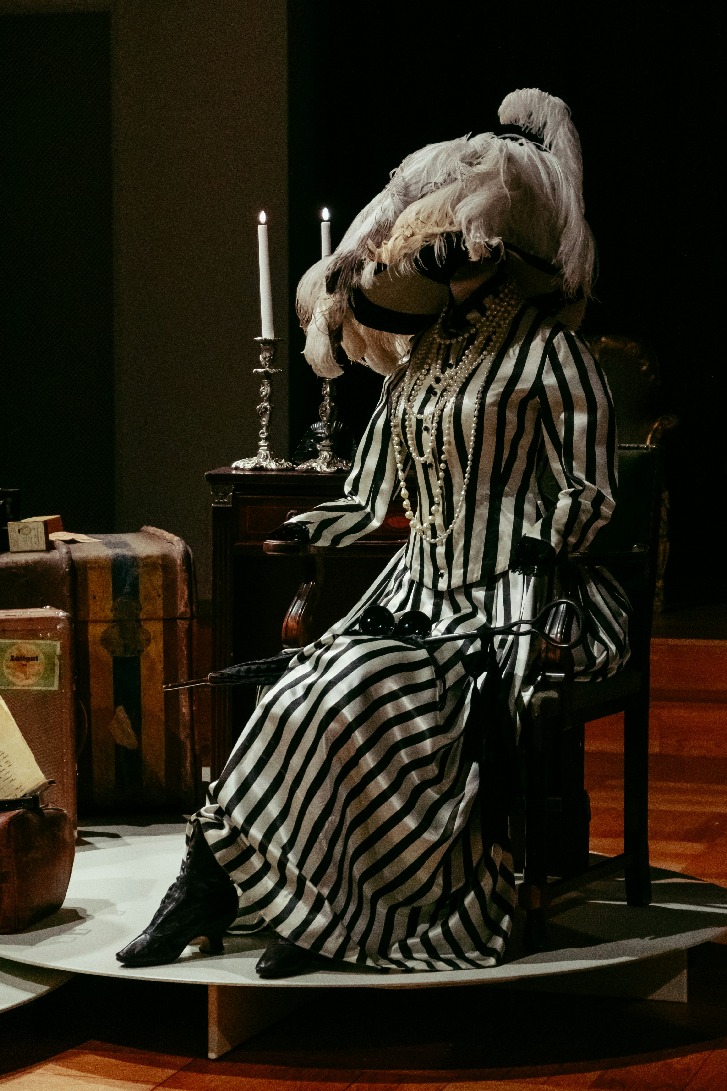 person in black and white stripe robe sitting on chair